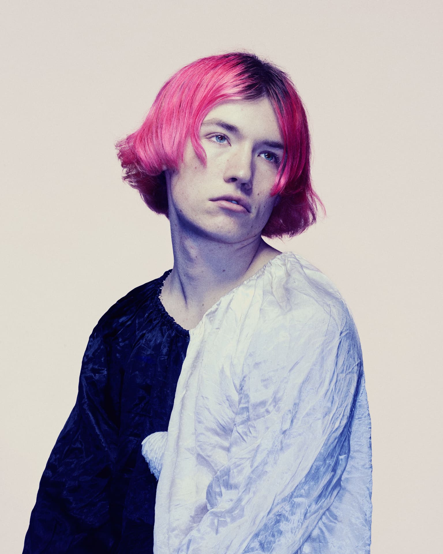 young man with pink hair and a clowns outfit